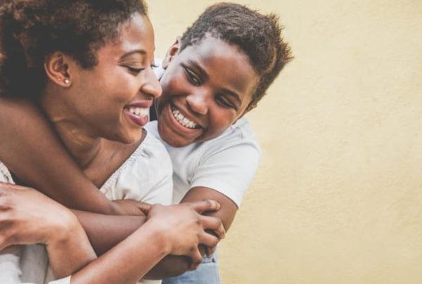 mother and daughter embracing and smiling