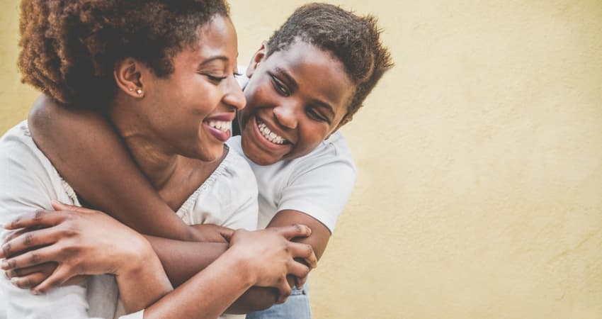 a mother and daughter hugging and smiling