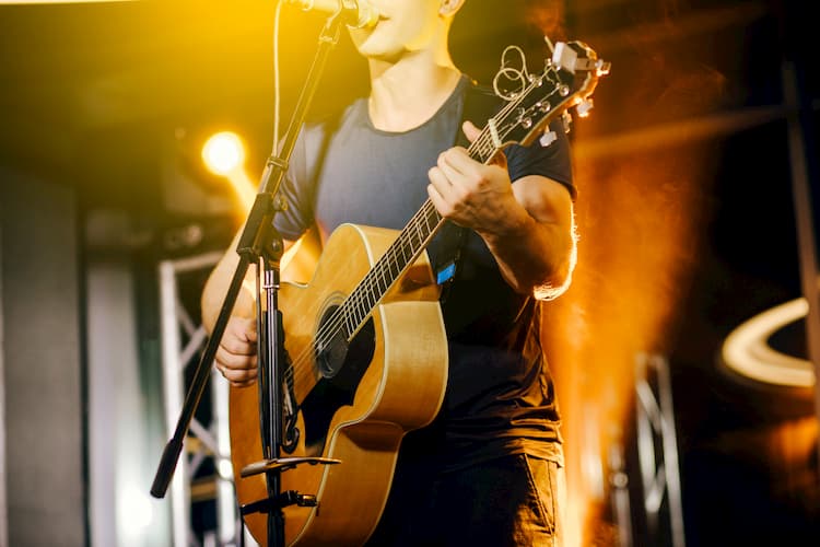 a man playing guitar on stage