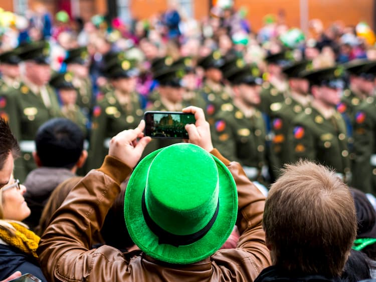 people taking photos at a st patricks day parade