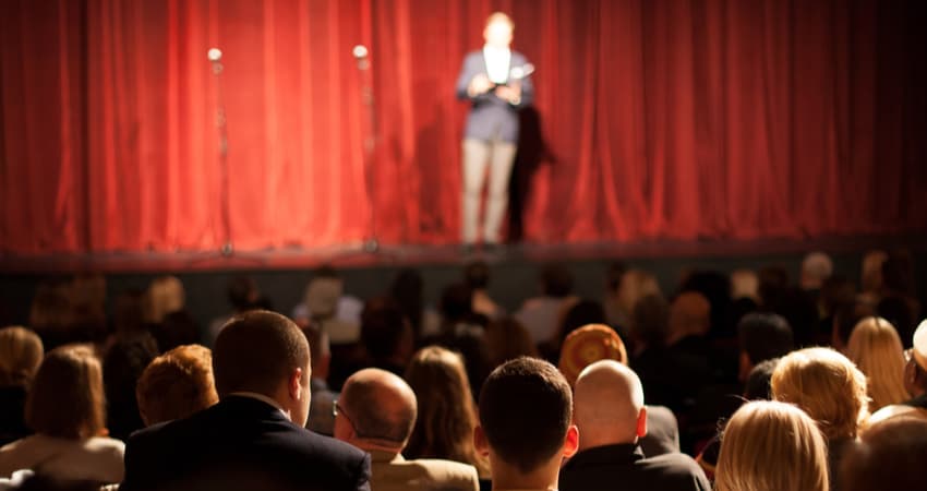 an entertainer on stage in front of a crowd