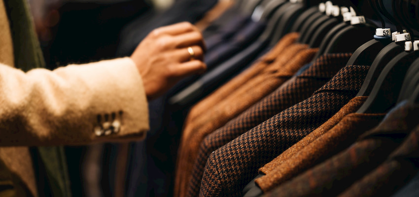 a mall visitor inspects a rack of suit jackets at the Mall at Millennia in Orlando Florida