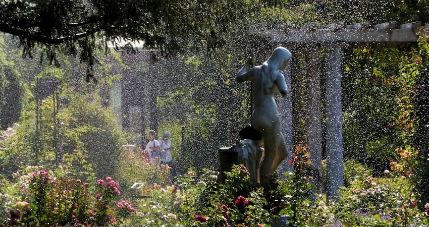 a misty rain settles over metal statues and surrounding gardens at Albin Polasek Museum & Sculpture Gardens near Orlando Florida