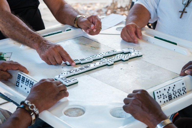 Elderly people's hands playing dominos in Domino Park