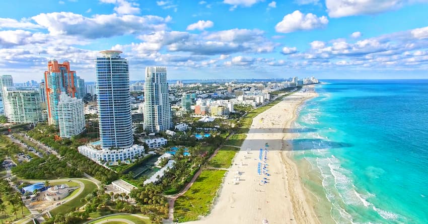 bright blue water beach in miami and miami skyline