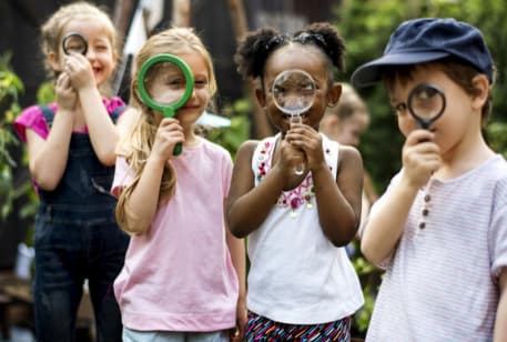 Kids on a field trip with magnifying glasses