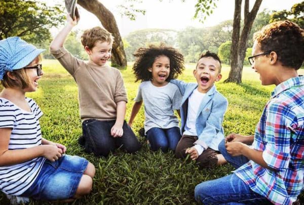 Kids sitting in circle on grass