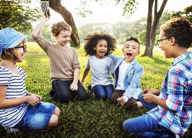 Kids sitting in circle on grass