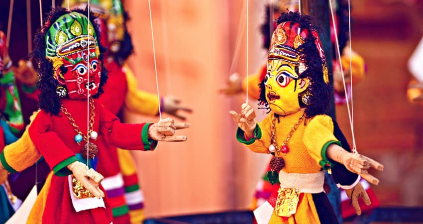 two marionettes interact during a live puppet show