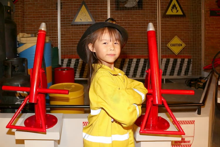 Little girl dressed up as firefighter