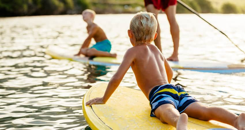 Children and parents paddleboarding