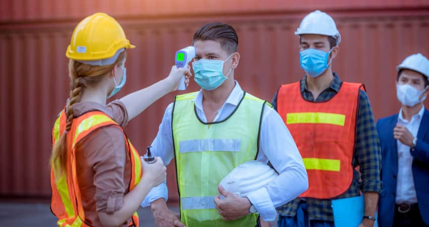 People being temperature screened at a construction site