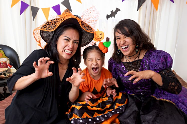 Two women and a child in Halloween costumes