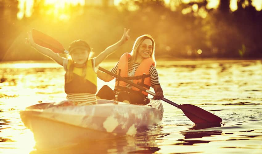 A woman and child kayaking on the river