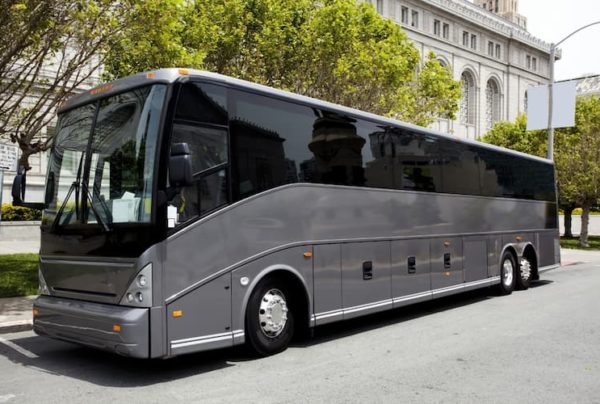 Gray tour bus outside building