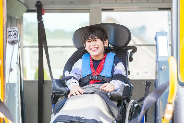 Little boy using wheelchair on bus