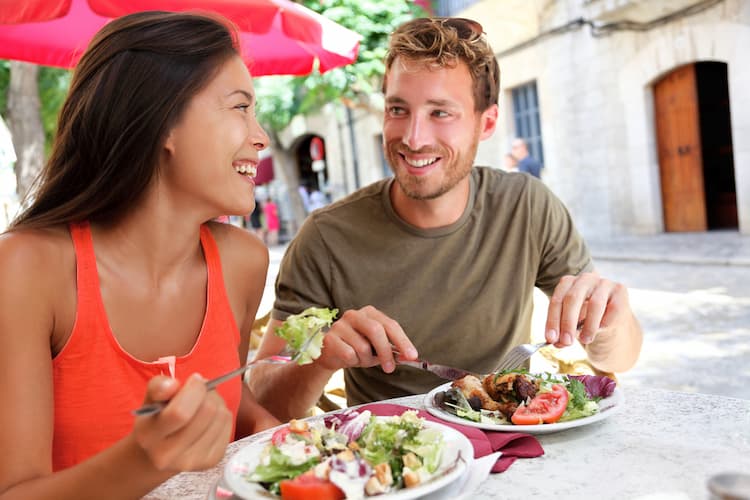 Young couple eating salad together