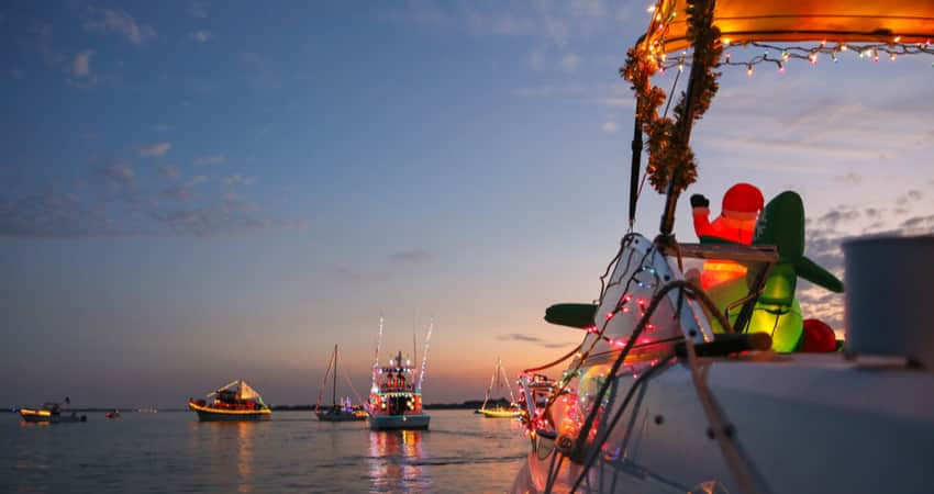 View from a decorated boat for a holiday boat parade at sunset 