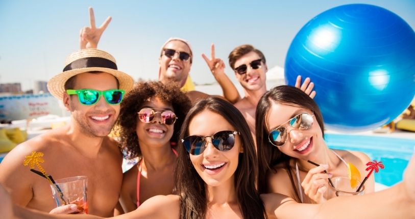 Group of friends laughing and smiling in pool