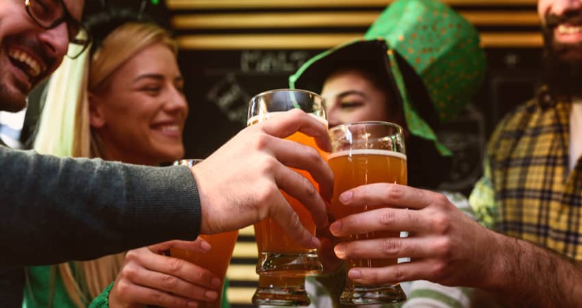 Friends toasting beer at a bar on St Patrick's Day