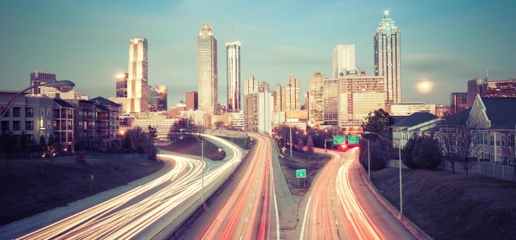 A timelapse photo of an Atlanta freeway with the skyline in the background.