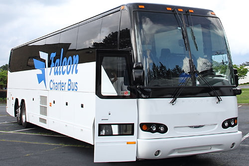 A white branded Falcon Charter Bus rental