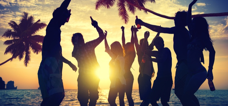 A group of people partying on the beach