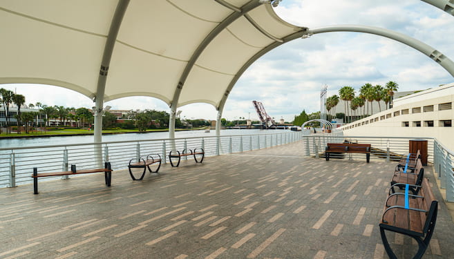 a covered sitting area on the tampa riverwalk overlooking the river